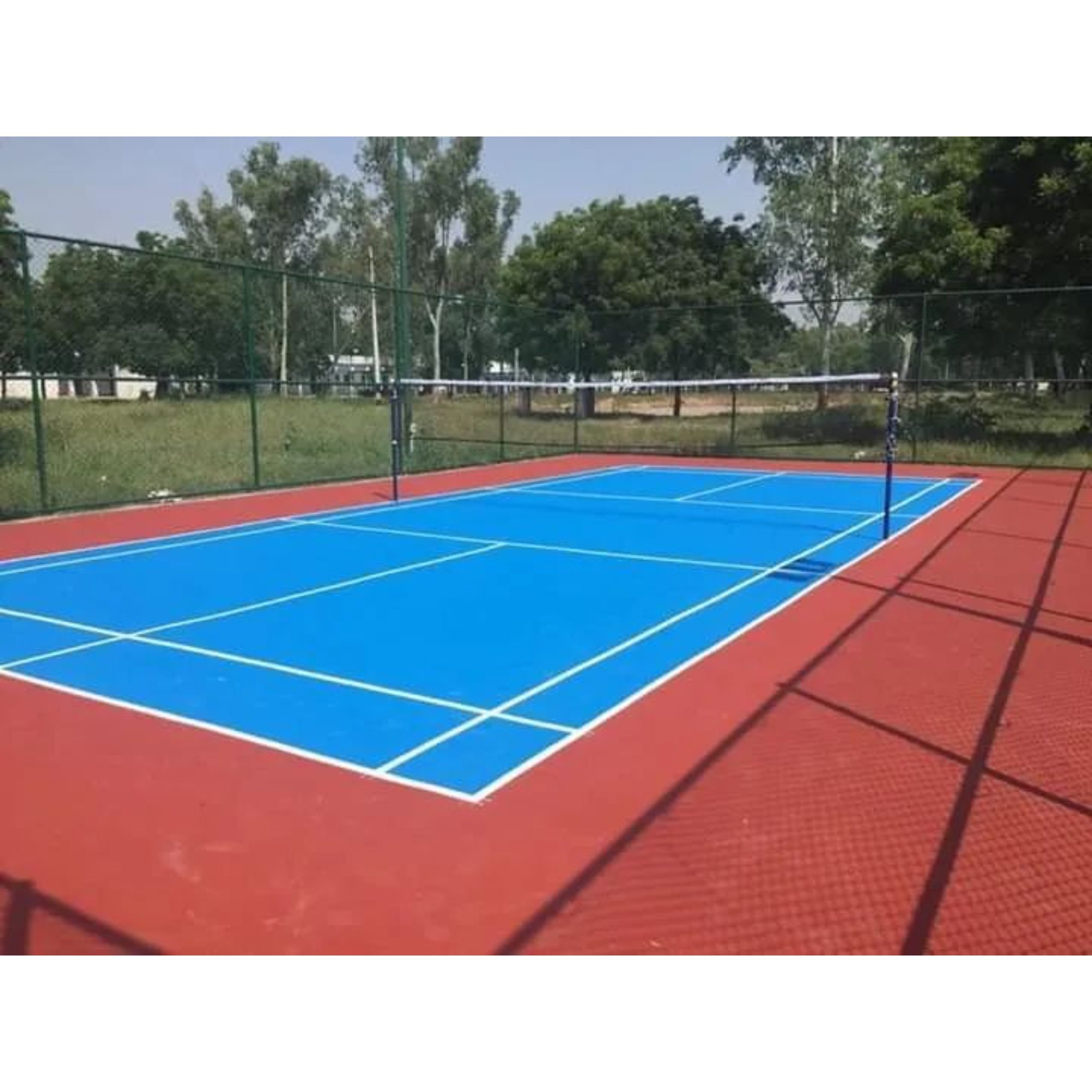 Volleyball court with blue surface and red surrounding area