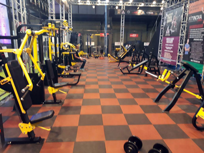 Gym with checkered orange and gray rubber tile flooring