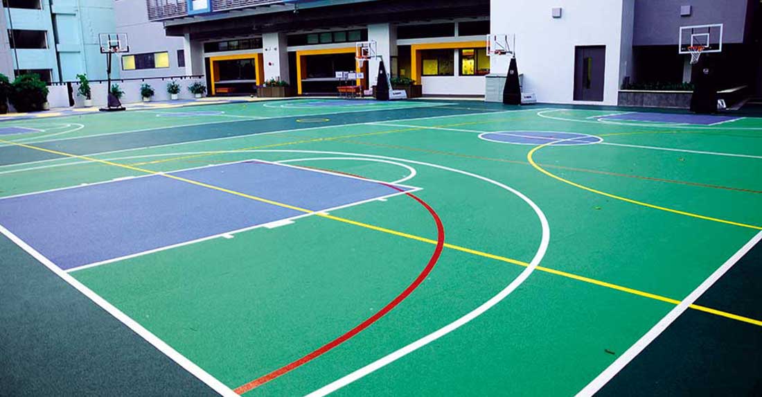 Outdoor rubber sports court with colorful markings