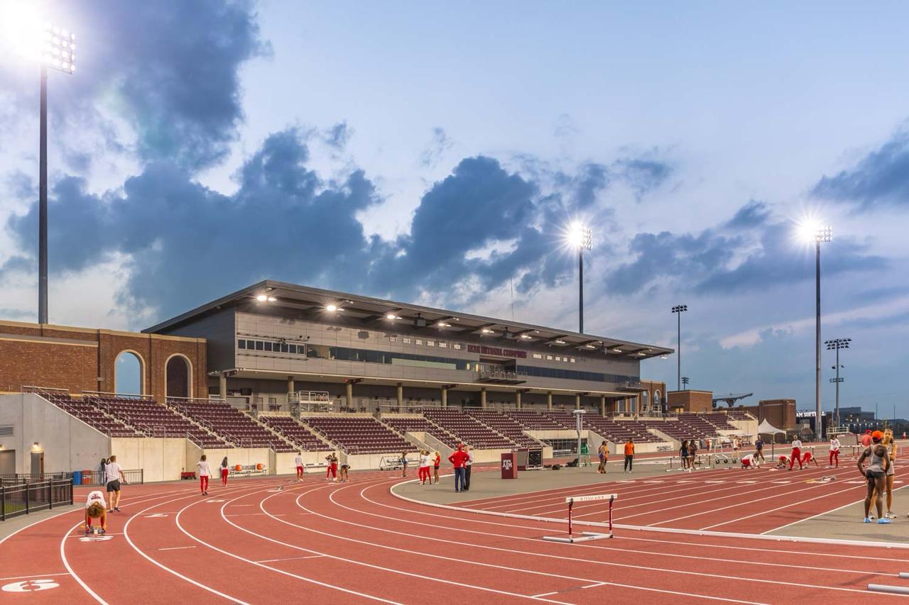 Running Track Flooring - Stadium with Athletes Training on Red Track