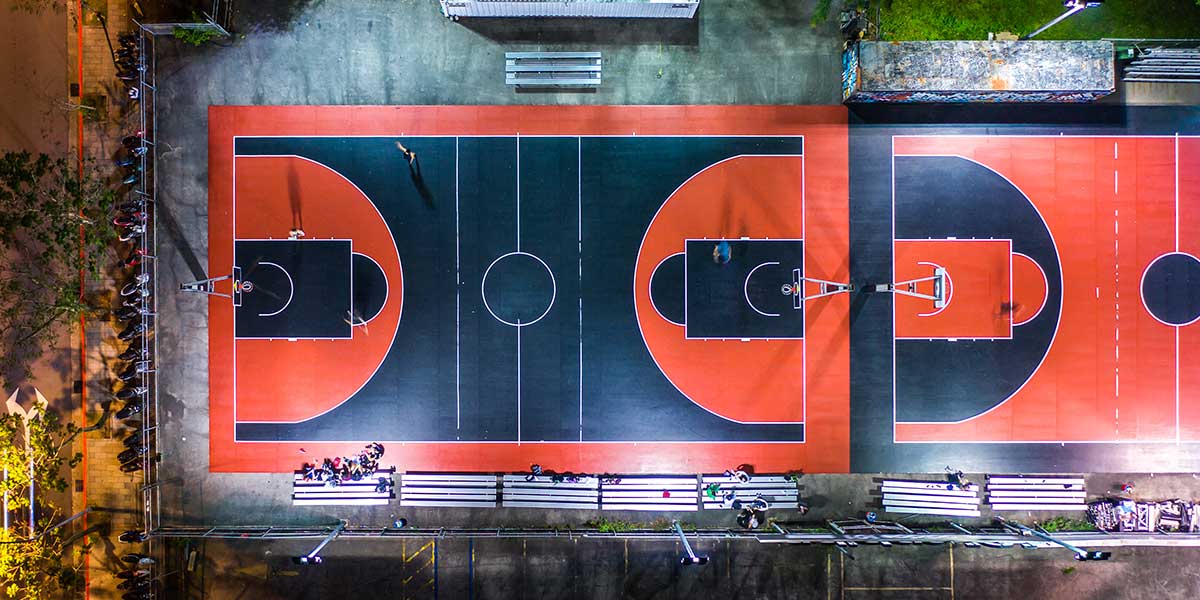 Stunning aerial view of basketball court with orange and navy blue color scheme